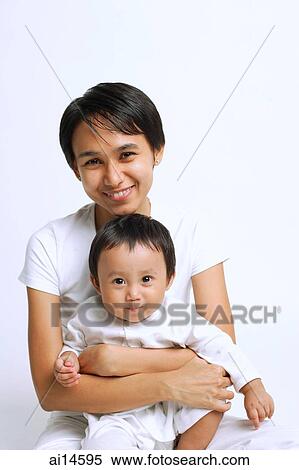 Mother with baby boy, looking at camera, portrait View Large Photo Image Stock Photography - Mother with baby boy, looking at camera, portrait. Fotosearch