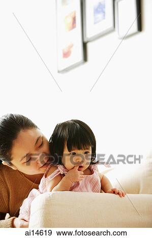 Mother with baby girl, on sofa, looking away View Large Photo Image Stock Photo - Mother with baby girl, on sofa, looking away. Fotosearch