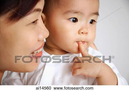 Mother with baby, head shot, looking away View Large Photo Image Stock Image - Mother with baby, head shot, looking away. Fotosearch