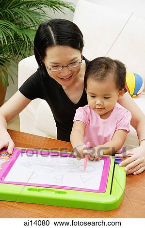 Mother with daughter, drawing on magnetic block View Large Photo Image Stock Image - Mother with daughter, drawing on magnetic block. Fotosearch