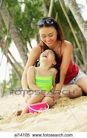 Mother with daughter on beach, laughing, portrait View Large Photo Image Stock Photography - Mother with daughter on beach, laughing, portrait. Fotosearch