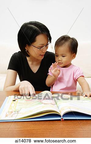 Mother with daughter, reading storybook View Large Photo Image Stock Photo - Mother with daughter, reading storybook. Fotosearch