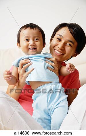 Stock Photo - Mother with infant son, portrait. Fotosearch