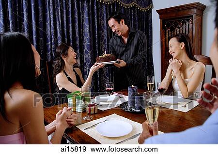 Party at home, women accepting birthday cake from man View Large Photo Image Stock Photo - Party at home, women accepting birthday cake from man. Fotosearch