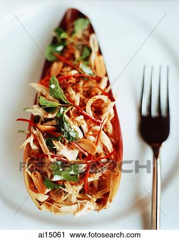 Stock Image - Spicy chicken salad in banana heart. Fotosearch