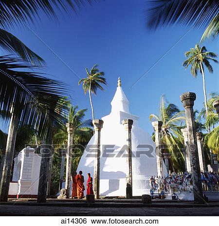 Stock Photograph - Sri Lanka, Mihitale, Ambasthala Dagoba, Monks praying in foreground. Fotosearch
