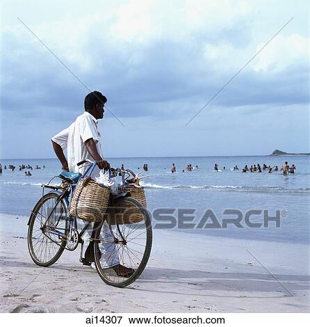 Sri Lanka, Trincomalee, local man selling sea shells, with bicycle, o beach View Large Photo Image Stock Photo - Sri Lanka, Trincomalee, local man selling sea shells, with bicycle, o beach. Fotosearch