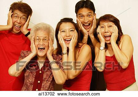 Stock Image - Three generation family, looking at camera, hands on head, screaming. Fotosearch