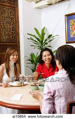 Three women having a conversation over a meal View Large Photo Image Picture - Three women having a conversation over a meal. Fotosearch