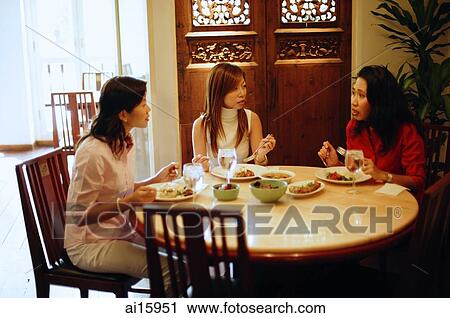 Three women having a meal at restaurant, talking View Large Photo Image Stock Image - Three women having a meal at restaurant, talking. Fotosearch