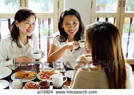 Three women having tea at cafe View Large Photo Image Picture - Three women having tea at cafe. Fotosearch