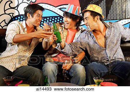Three young men, at entertainment club, toasting View Large Photo Image Stock Image - Three young men, at entertainment club, toasting. Fotosearch