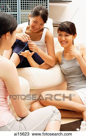 Three young women on sofa, talking View Large Photo Image Stock Image - Three young women on sofa, talking. Fotosearch