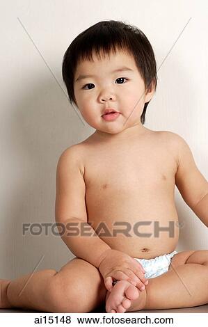 Toddler in diapers, sitting and looking at camera View Large Photo Image Stock Photo - Toddler in diapers, sitting and looking at camera. Fotosearch