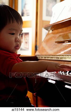 Toddler playing the piano View Large Photo Image Picture - Toddler playing the piano. Fotosearch