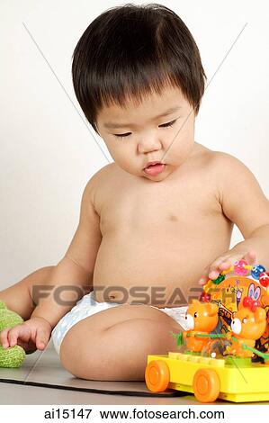 Toddler sitting, playing with toys View Large Photo Image Stock Photo - Toddler sitting, playing with toys. Fotosearch