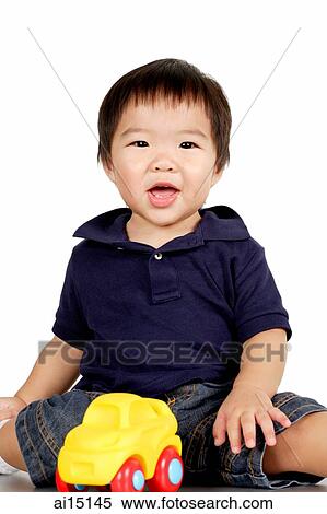 Toddler sitting with toy car, smiling View Large Photo Image Stock Photography - Toddler sitting with toy car, smiling. Fotosearch