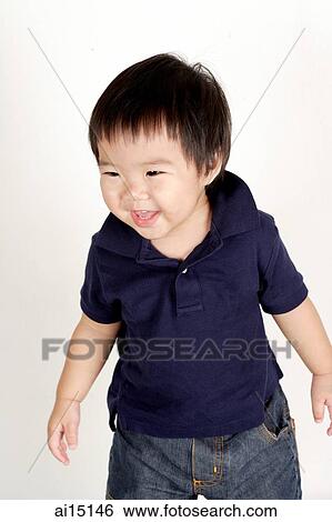 Stock Photograph - Toddler standing, smiling. Fotosearch