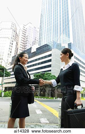Two business women shaking hands View Large Photo Image Stock Photo - Two business women shaking hands. Fotosearch