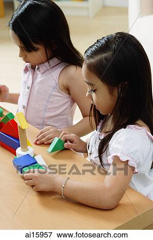 Two girls playing with building blocks View Large Photo Image Stock Photo - Two girls playing with building blocks. Fotosearch