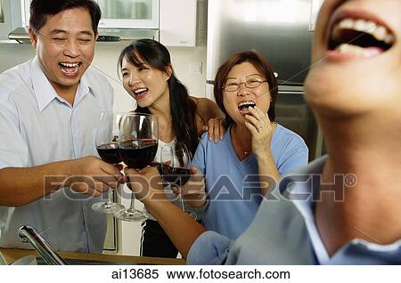 Two men and two women, in kitchen, toasting with wine glasses, laughing View Large Photo Image Stock Photography - Two men and two women, in kitchen, toasting with wine glasses, laughing. Fotosearch