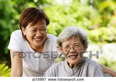 Two women, smiling at camera View Large Photo Image Stock Photo - Two women, smiling at camera. Fotosearch