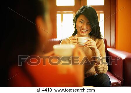 Two young women drinking tea View Large Photo Image Stock Photo - Two young women drinking tea. Fotosearch