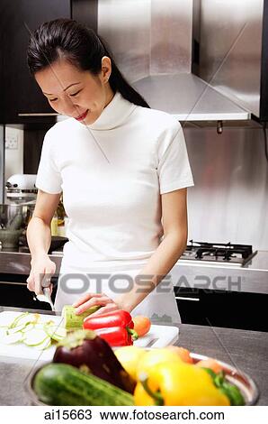 Woman cutting vegetables, smiling View Large Photo Image Stock Image - Woman cutting vegetables, smiling. Fotosearch