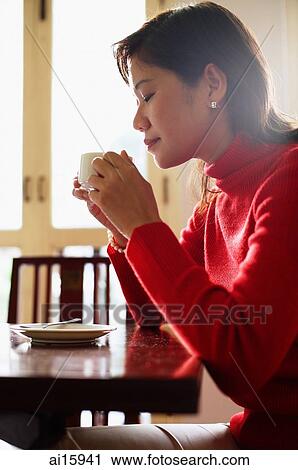 Woman drinking from cup, side view View Large Photo Image Stock Image - Woman drinking from cup, side view. Fotosearch