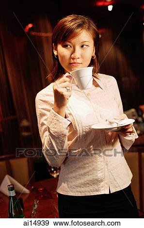 Woman holding cup and saucer, looking away View Large Photo Image Stock Photo - Woman holding cup and saucer, looking away. Fotosearch