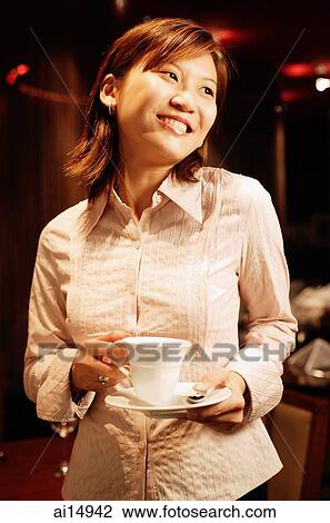 Woman holding cup and saucer, smiling View Large Photo Image Stock Image - Woman holding cup and saucer, smiling. Fotosearch