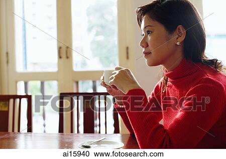 Woman holding cup, looking away, side view View Large Photo Image Stock Image - Woman holding cup, looking away, side view. Fotosearch