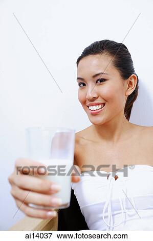 Stock Photo - Woman holding glass of milk. Fotosearch