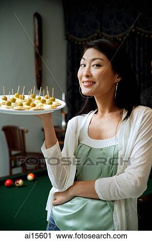 Woman holding tray of appetizers, smiling at camera View Large Photo Image Stock Image - Woman holding tray of appetizers, smiling at camera. Fotosearch
