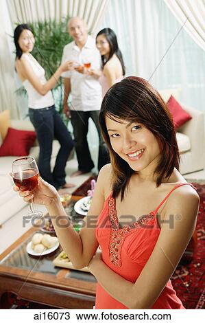 Woman holding wine glass, smiling at camera, arms crossed View Large Photo Image Stock Image - Woman holding wine glass, smiling at camera, arms crossed. Fotosearch