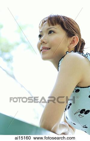 Woman leaning on railing, looking away View Large Photo Image Stock Image - Woman leaning on railing, looking away. Fotosearch