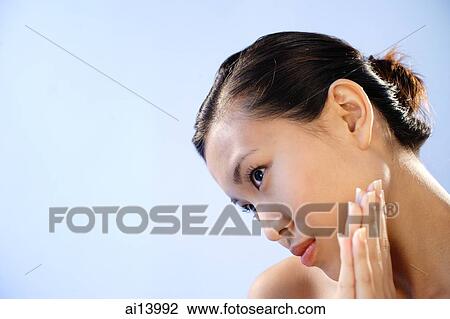 Stock Image - Woman looking away, head bent down. Fotosearch