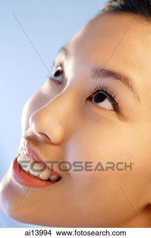 Picture - Woman looking upwards, close up. Fotosearch