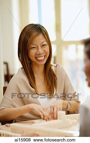 Woman playing mahjong View Large Photo Image Stock Photo - Woman playing mahjong. Fotosearch