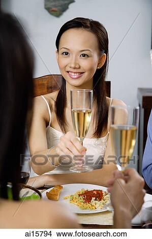 Woman raising glass in toast View Large Photo Image Picture - Woman raising glass in toast. Fotosearch
