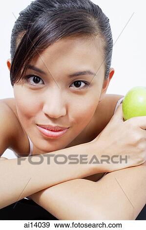 Woman resting head on arms, holding camera View Large Photo Image Stock Photo - Woman resting head on arms, holding camera. Fotosearch