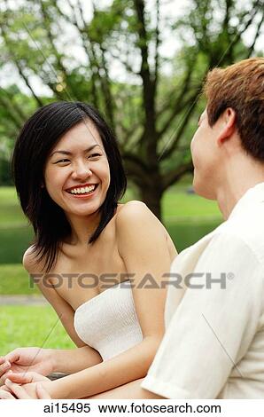 Woman smiling at man sitting next to her View Large Photo Image Stock Photography - Woman smiling at man sitting next to her. Fotosearch