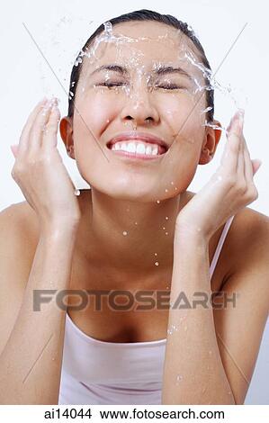 Woman splashing face with water View Large Photo Image Picture - Woman splashing face with water. Fotosearch