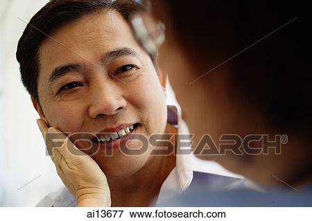 Woman touching man's face View Large Photo Image Stock Photo - Woman touching man's face. Fotosearch
