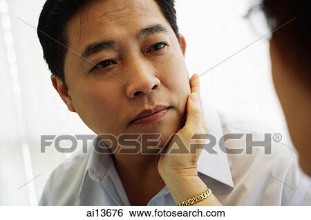 Woman touching man's face View Large Photo Image Stock Photograph - Woman touching man's face. Fotosearch