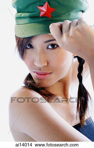 Woman wearing cap, looking at camera View Large Photo Image Picture - Woman wearing cap, looking at camera. Fotosearch