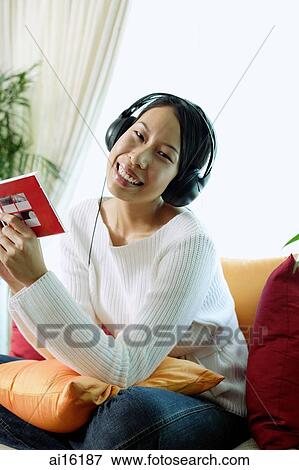 Woman wearing headphones, smiling View Large Photo Image Stock Photo - Woman wearing headphones, smiling. Fotosearch