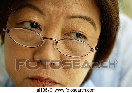 Woman with glasses, looking away, headshot View Large Photo Image Stock Photo - Woman with glasses, looking away, headshot. Fotosearch