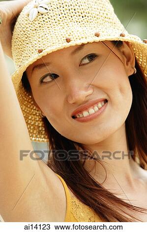 Woman with hand on head, looking away View Large Photo Image Stock Image - Woman with hand on head, looking away. Fotosearch