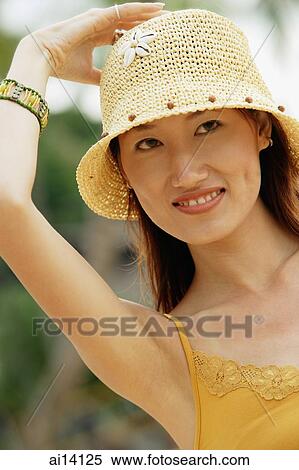Woman with hand on head, looking away, portrait View Large Photo Image Stock Photography - Woman with hand on head, looking away, portrait. Fotosearch